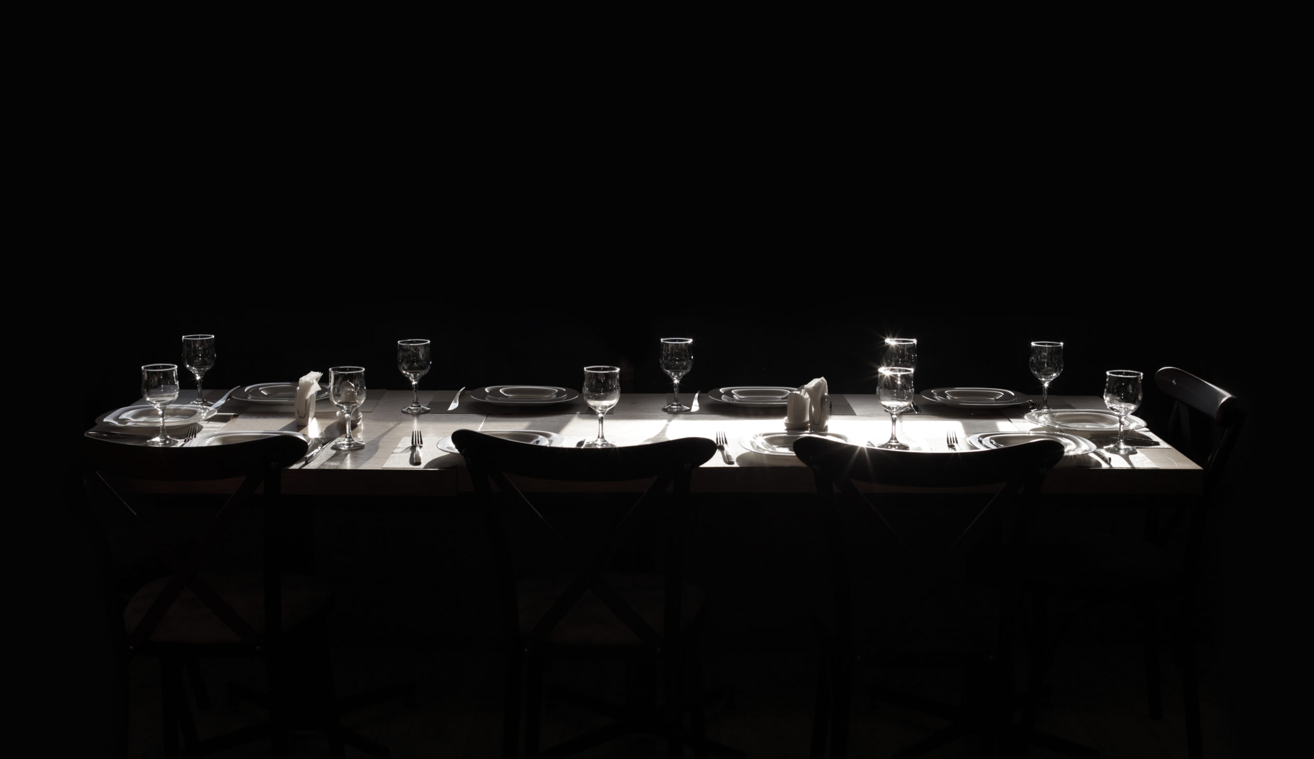 a dining table set in the dark