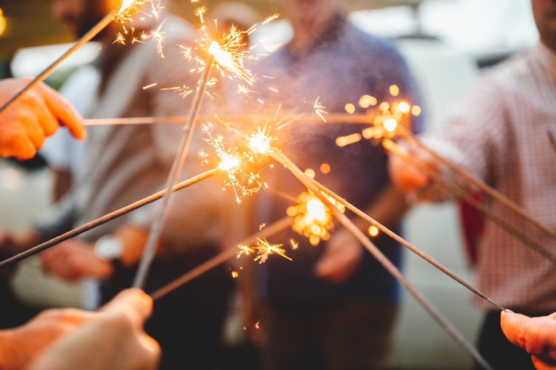 people holding sparklers at a party