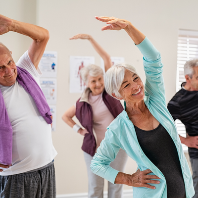 seniors in a group class stretching