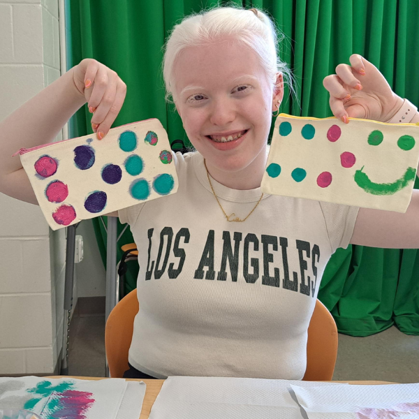 young visually impaired girl with a painted braille project