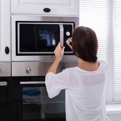 person using a microwave