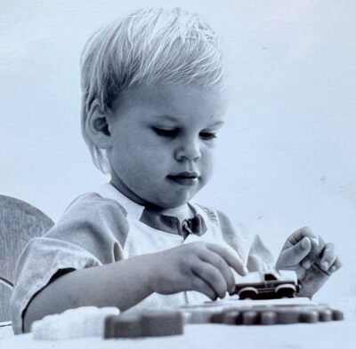 Susan's Son Alex at a young age playing with a toy