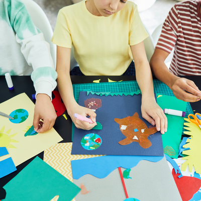 people creating crafts on a table