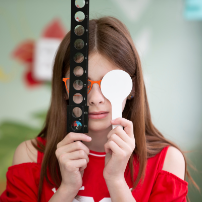 a girl examines her eyes