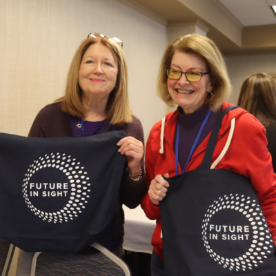 two women at silver retreat smiling at the camera while holding their Future In Sight bags