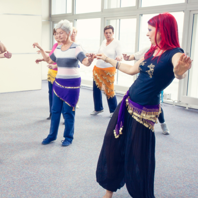 group of people learning belly dancing