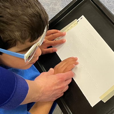 a child learning to read braille