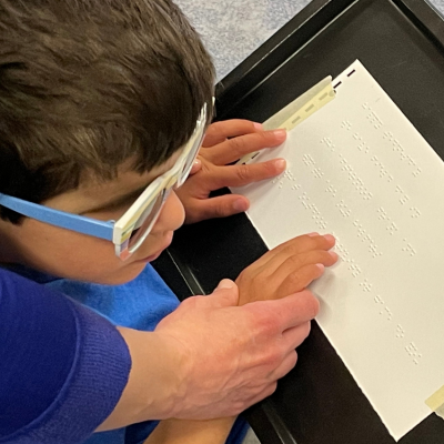 student reading braille