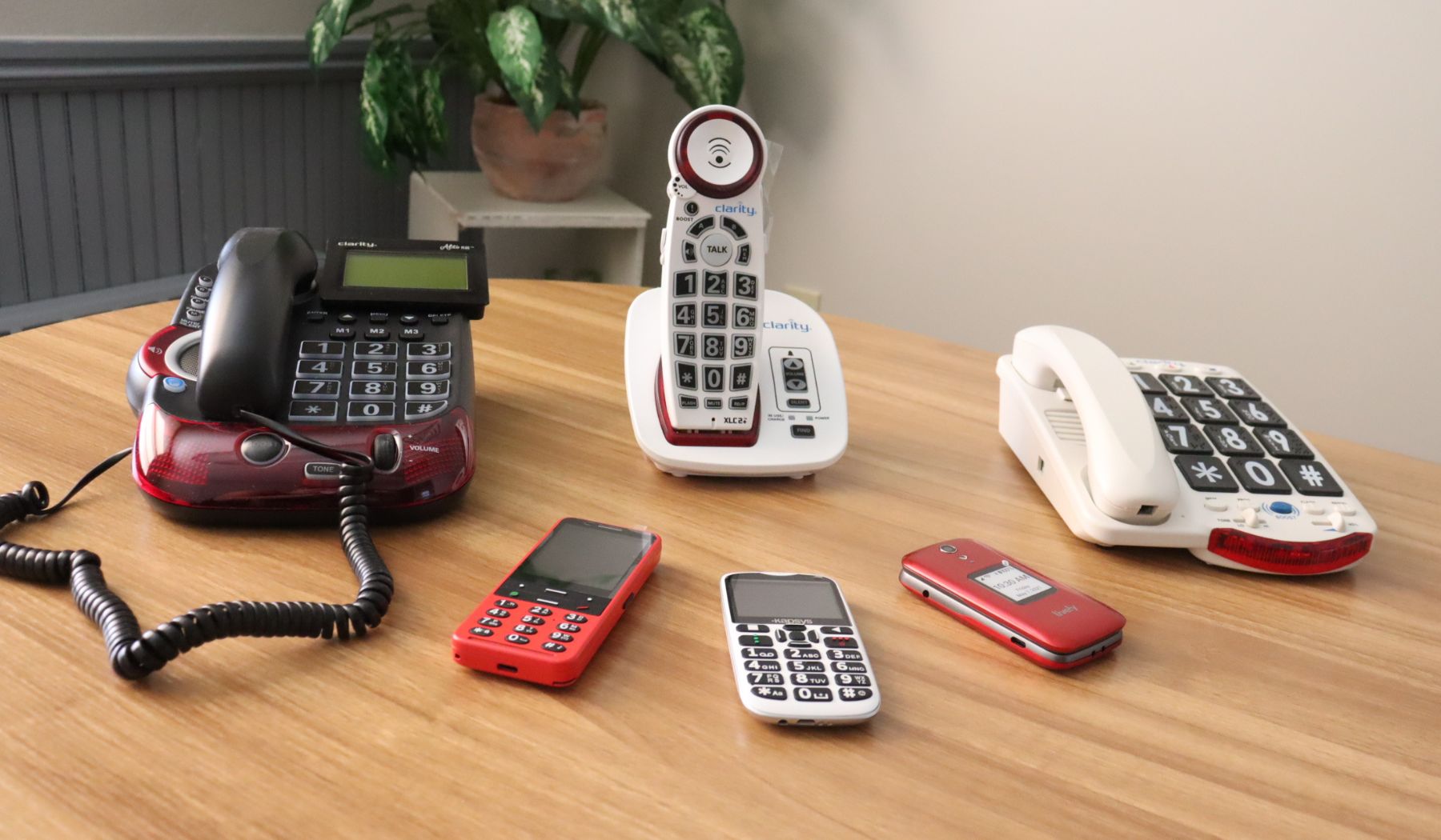 assortment of TEAP telephones and cellphones arranged on a table