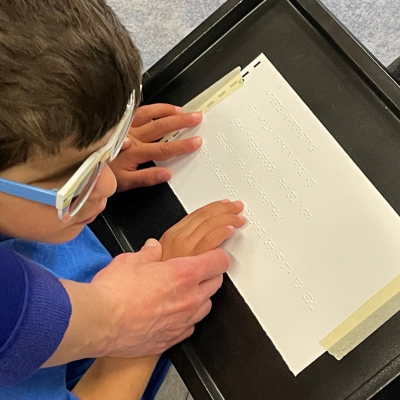 student learning braille
