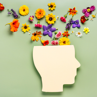 a person's head with flowers coming out the top to signify good mental health