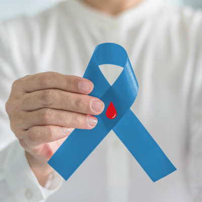 hand holding a ribbon to represent diabetic eye disease awareness