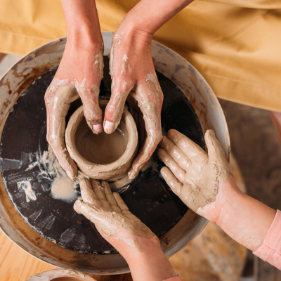 hands creating pottery