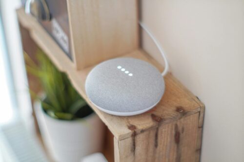 A voice assistant device on a shelf.