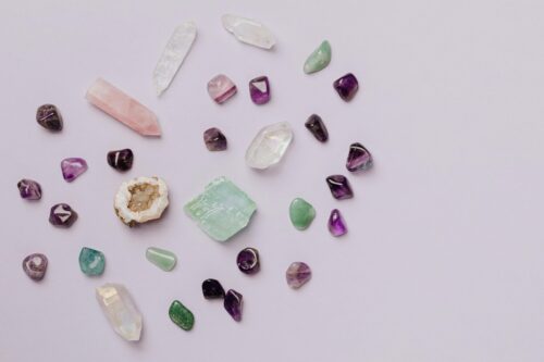 An assortment of colorful crystals spread out over a purple background.