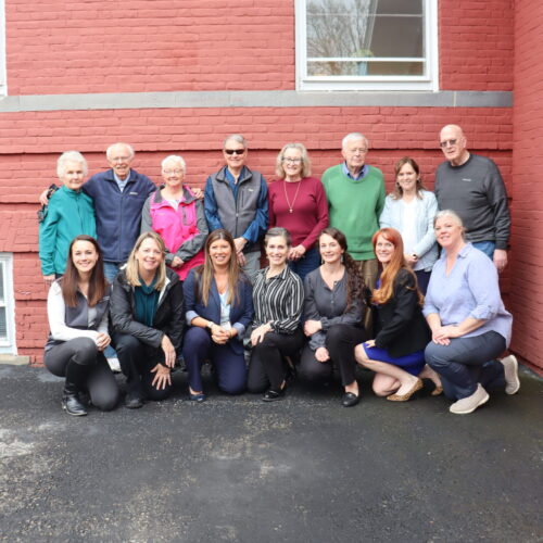 A group of Silver Retreat participants posing for a photo with the Future In Sight staff kneeling in front of them.