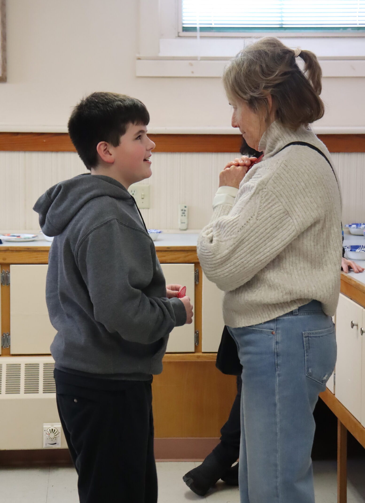A boy speaks to his teacher.