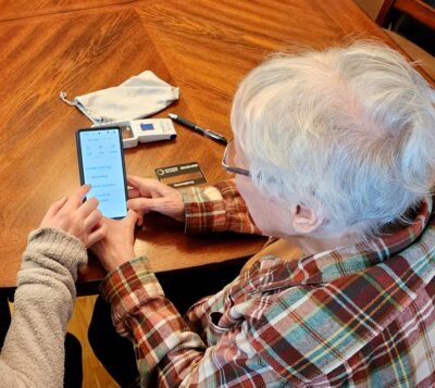 A senior woman uses a smart phone.