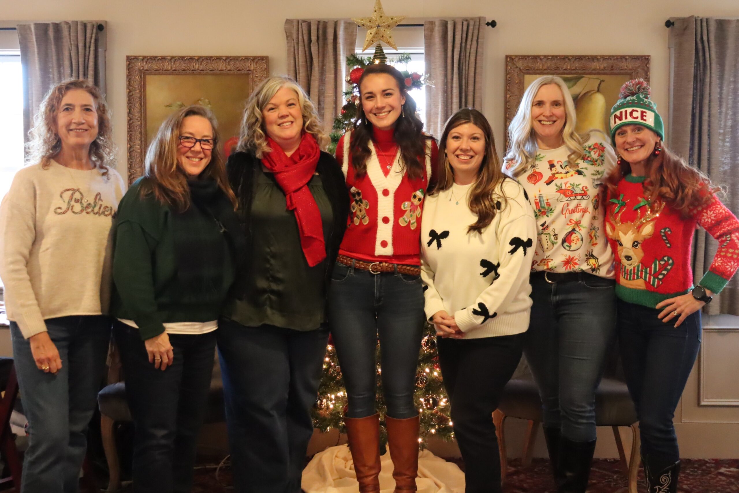 The Adult Services team posing in front of the tree.