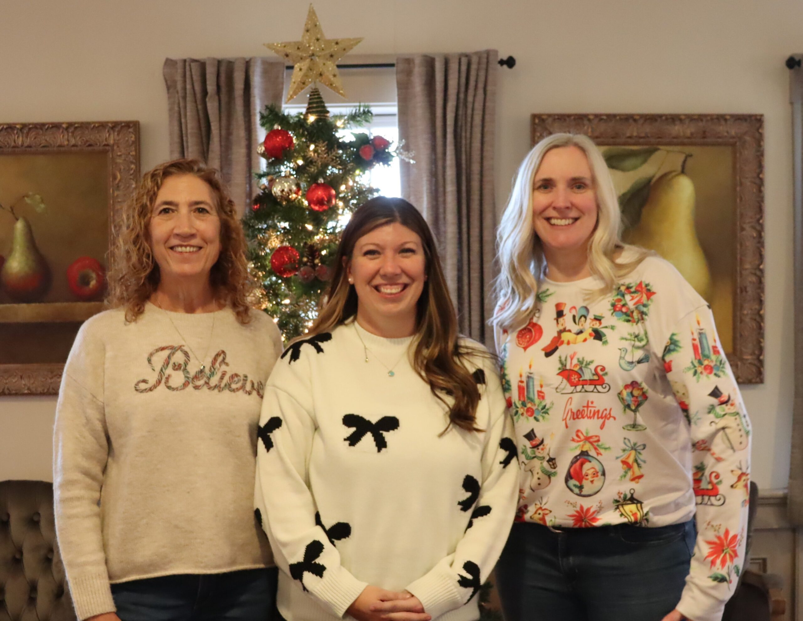 Kim B., Bri and Michelle in front of the Christmas tree.