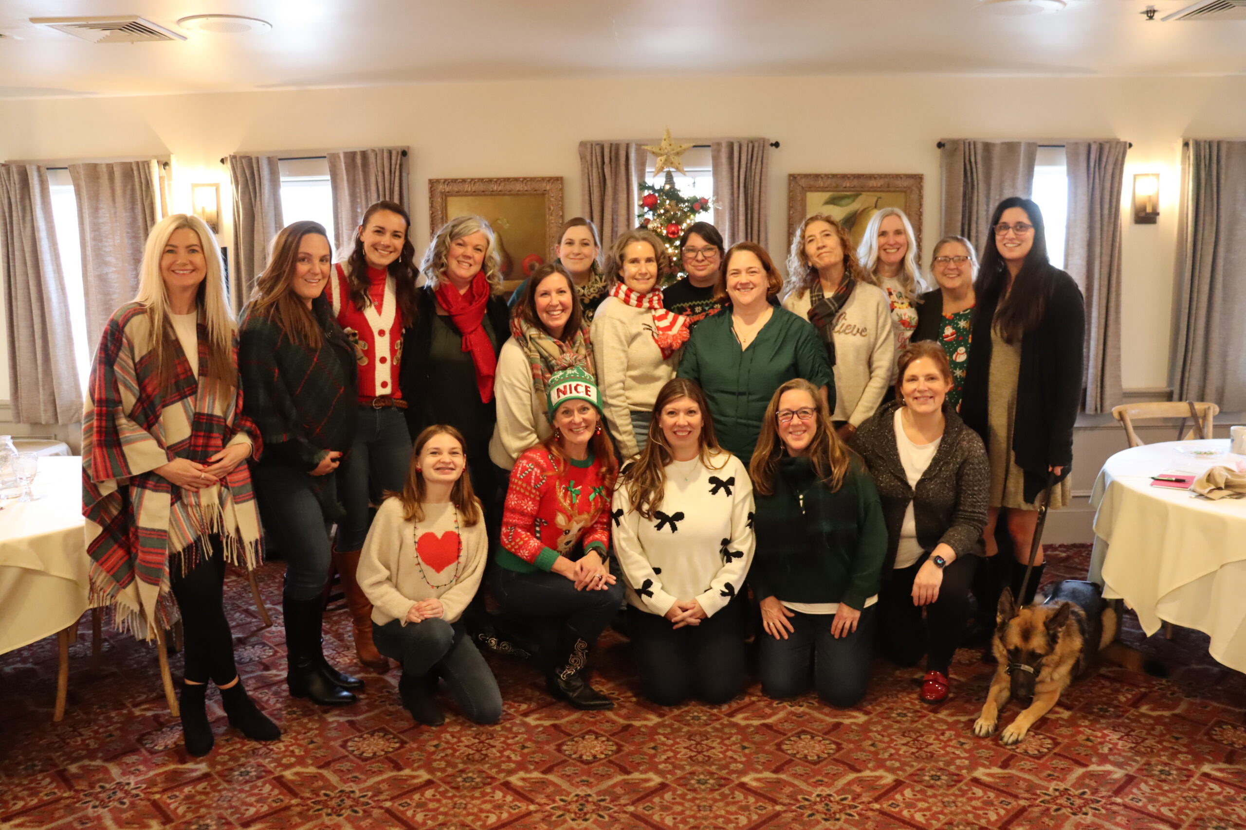 The full staff grouped in front of the tree.