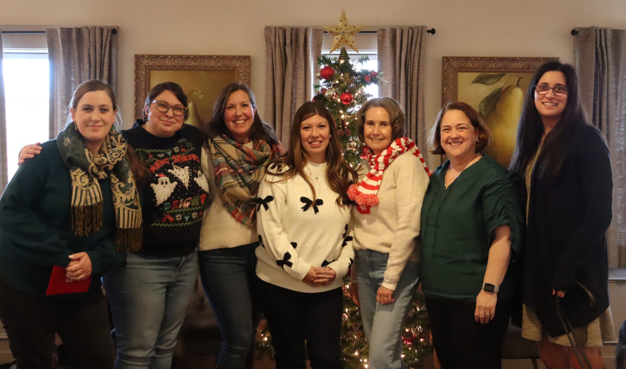 The Youth Services Team posing in front of the Christmas tree.