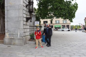 James, Dave Kenepp and Dave Hagan walking under the arch in front of the State House.