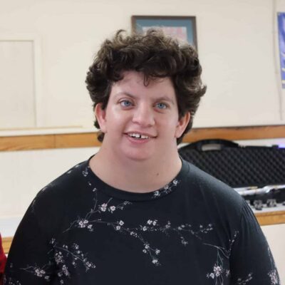 A young woman with a visual impairment posing for a photo.