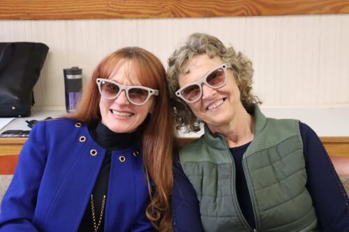Two individuals wearing Meta AI Smart Glasses posing and smiling together.